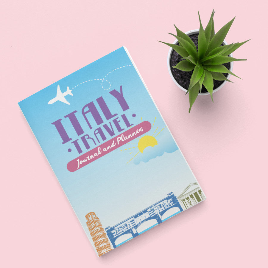 Travel Journal and Diary to Italy on a desk with a plant